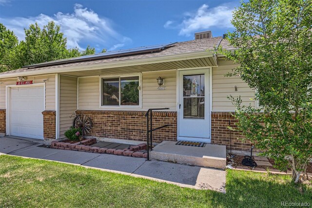 view of front of house with a garage and a front lawn