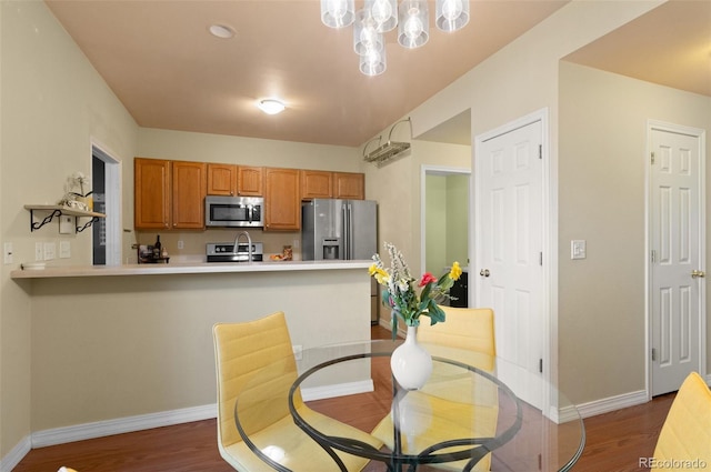 dining area with dark wood finished floors and baseboards