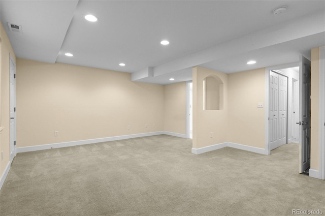 finished below grade area with recessed lighting, visible vents, light carpet, and baseboards