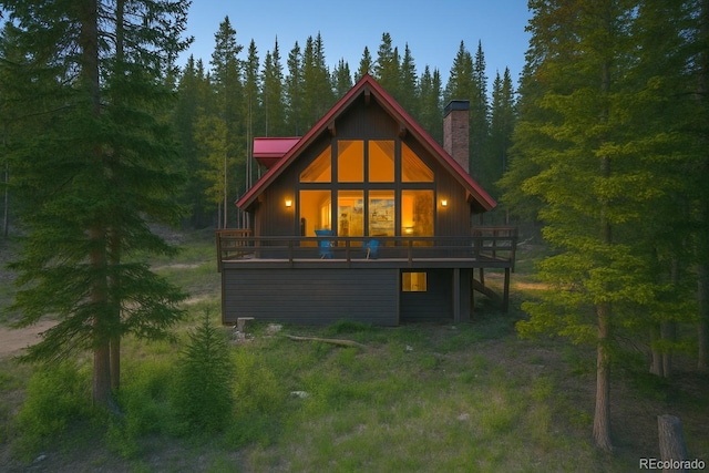 135 Nugget Ln, Alma, CO 80420 - rear view of house with a chimney, a view of trees, and a deck