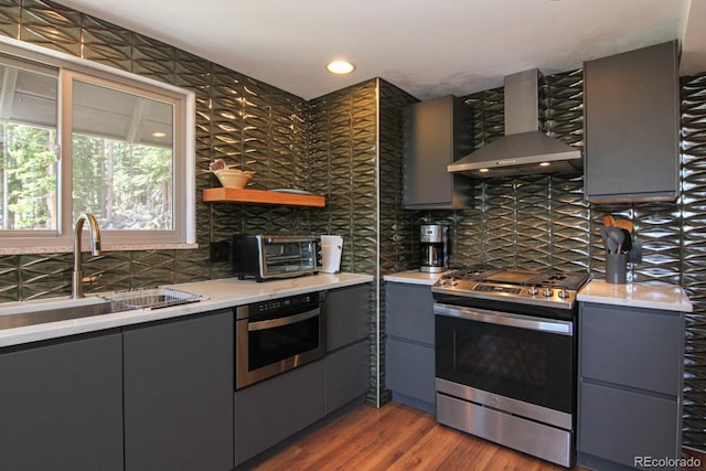 135 Nugget Ln, Alma, CO 80420 - kitchen with appliances with stainless steel finishes, wall chimney exhaust hood, gray cabinetry, tasteful backsplash, and recessed lighting
