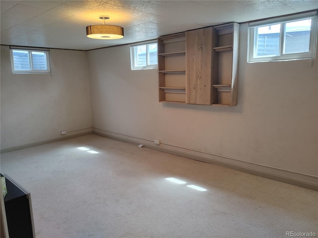 basement with carpet flooring and baseboards