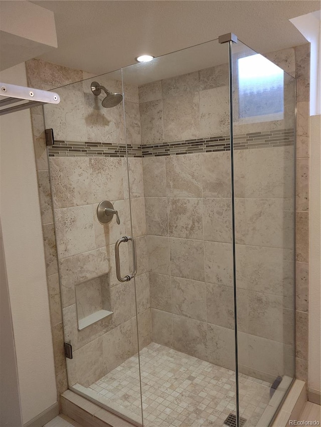 bathroom with a shower stall