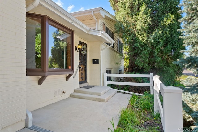 view of exterior entry featuring a patio