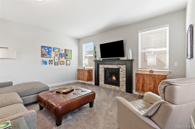 carpeted living room featuring a fireplace