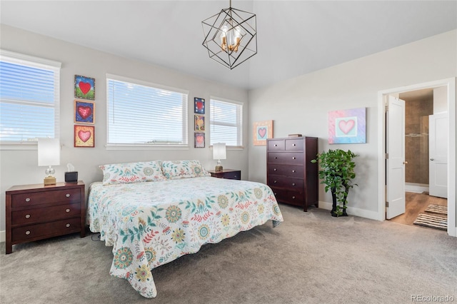 bedroom featuring light colored carpet and a chandelier