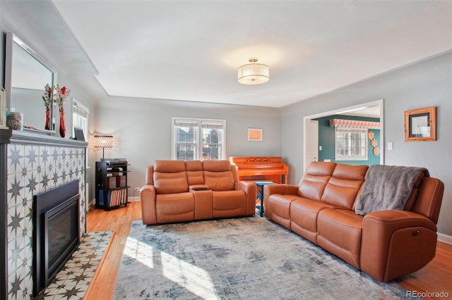 8001 W 57th Ave, Arvada, CO 80002 - living area featuring wood finished floors, baseboards, and a fireplace