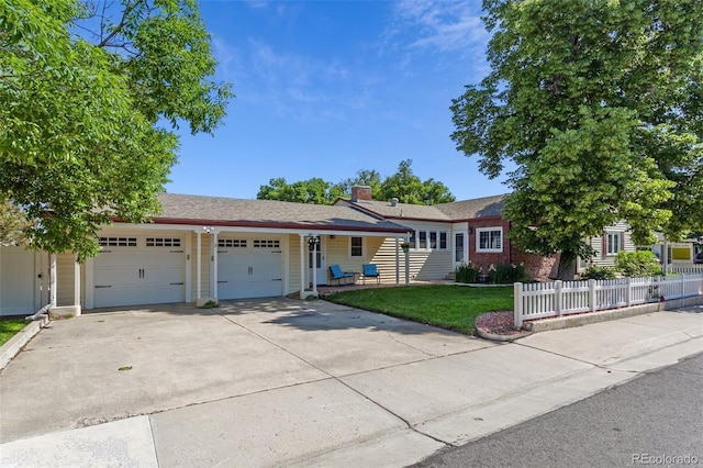 8001 W 57th Ave, Arvada, CO 80002 - ranch-style house featuring a garage, concrete driveway, and a chimney