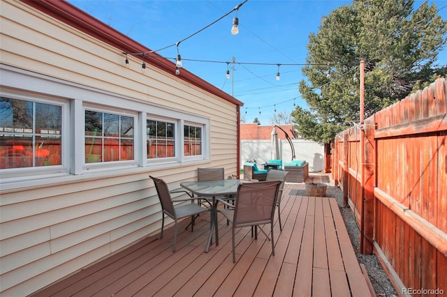 8001 W 57th Ave, Arvada, CO 80002 - wooden deck featuring outdoor dining space and a fenced backyard