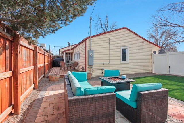 8001 W 57th Ave, Arvada, CO 80002 - back of house with an outdoor living space with a fire pit, a fenced backyard, a patio area, and a wooden deck