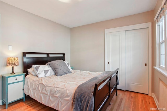 8001 W 57th Ave, Arvada, CO 80002 - bedroom featuring light wood finished floors, multiple windows, and a closet