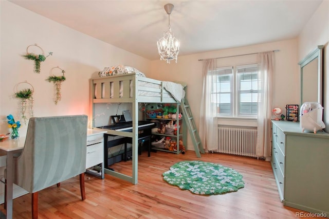 8001 W 57th Ave, Arvada, CO 80002 - bedroom with radiator, a chandelier, and light wood-type flooring