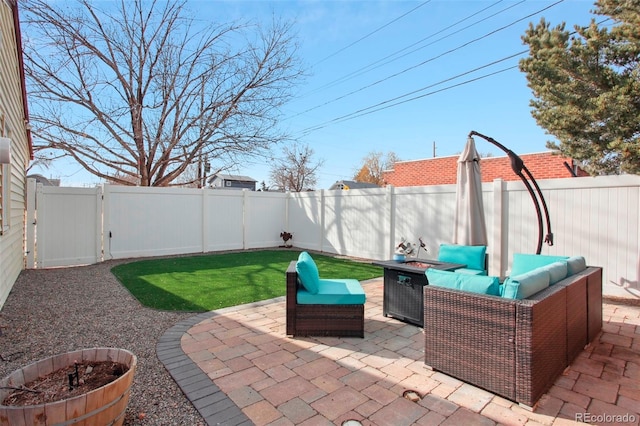 8001 W 57th Ave, Arvada, CO 80002 - fenced backyard featuring an outdoor living space with a fire pit and a patio area