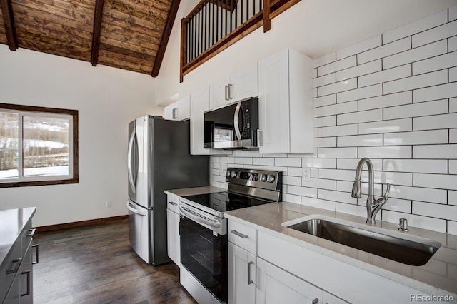 kitchen featuring dark wood-style floors, stainless steel appliances, tasteful backsplash, a sink, and wooden ceiling