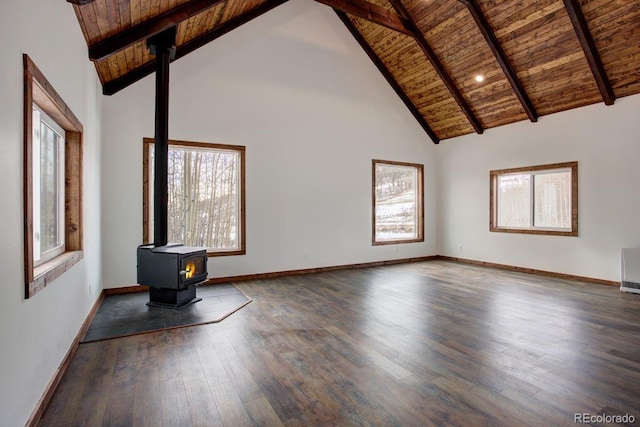 unfurnished living room with hardwood / wood-style floors, wooden ceiling, a wood stove, and baseboards