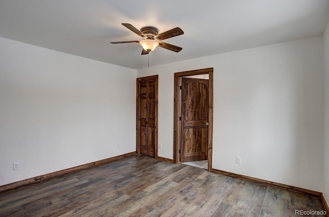 spare room featuring a ceiling fan, baseboards, and wood finished floors