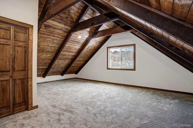 additional living space featuring vaulted ceiling with beams, baseboards, wood ceiling, and light colored carpet