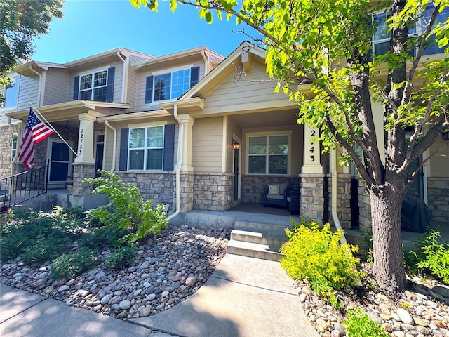 12743 W Bowles Pl, Littleton, CO 80127 - craftsman-style house featuring a porch and stone siding