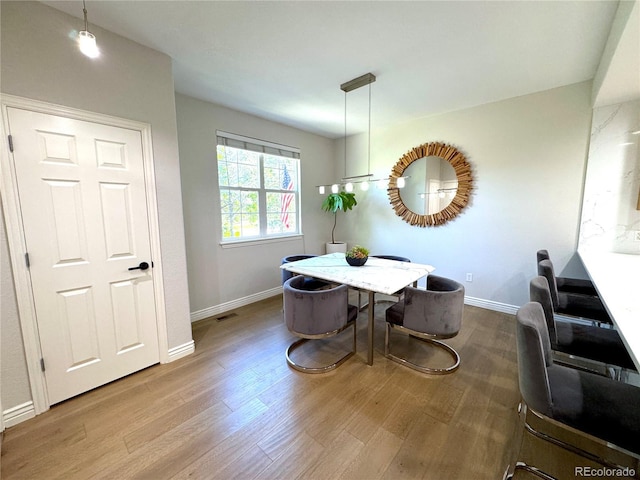 12743 W Bowles Pl, Littleton, CO 80127 - dining space featuring wood finished floors and baseboards