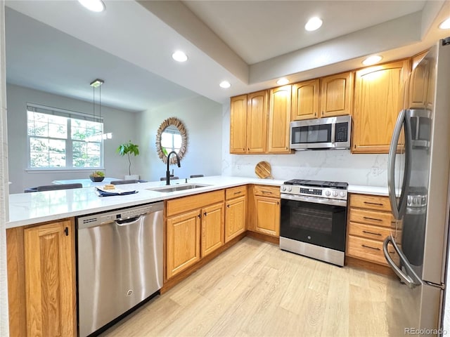12743 W Bowles Pl, Littleton, CO 80127 - kitchen with stainless steel appliances, a sink, light wood-style flooring, light countertops, and recessed lighting
