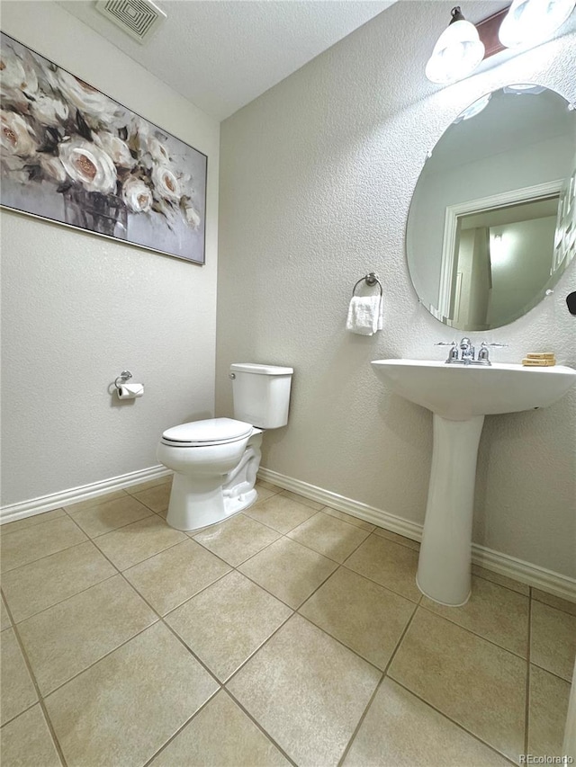 12743 W Bowles Pl, Littleton, CO 80127 - half bathroom featuring tile patterned flooring, toilet, and baseboards