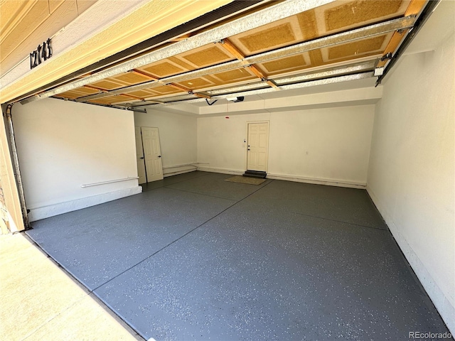 12743 W Bowles Pl, Littleton, CO 80127 - garage featuring baseboards and a garage door opener