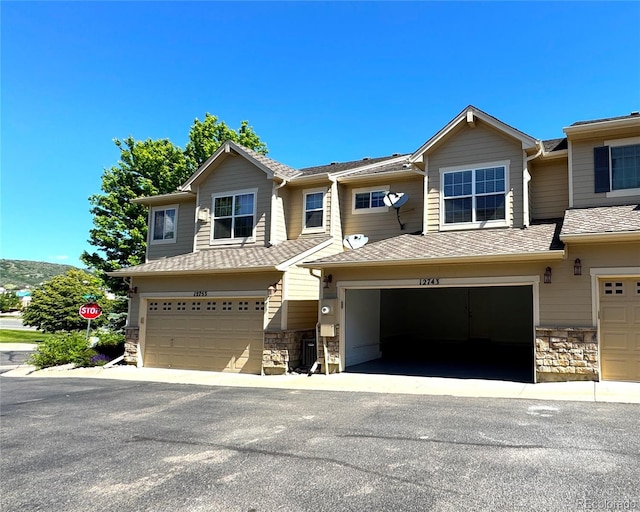 12743 W Bowles Pl, Littleton, CO 80127 - view of property featuring stone siding and a garage