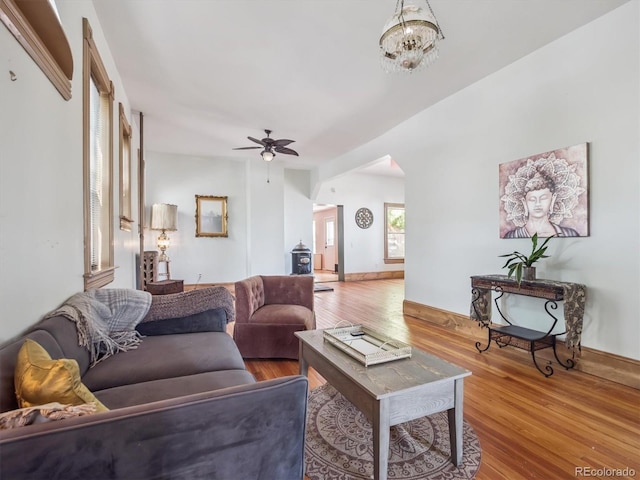 3 S Newton St, Denver, CO 80219 - living area featuring wood finished floors, a ceiling fan, arched walkways, and a chandelier