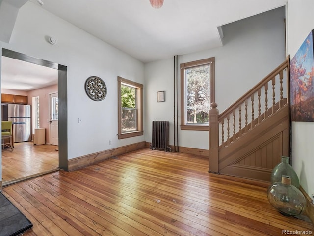 3 S Newton St, Denver, CO 80219 - entrance foyer with radiator heating unit, light wood-type flooring, healthy amount of natural light, and stairs