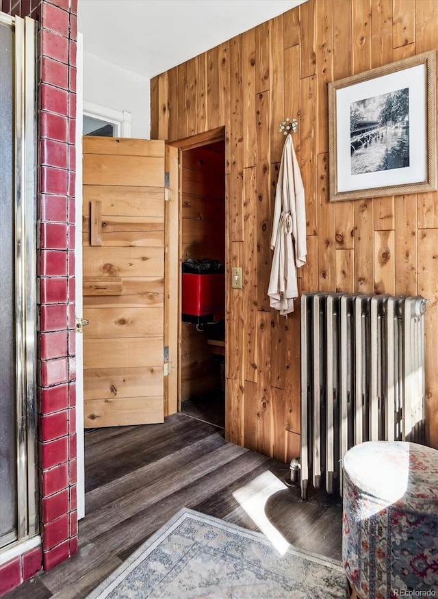 3 S Newton St, Denver, CO 80219 - bathroom with radiator heating unit, wood finished floors, and wood walls