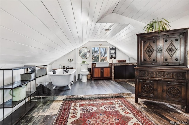 3 S Newton St, Denver, CO 80219 - bathroom featuring wood-type flooring, vaulted ceiling, a freestanding bath, and vanity