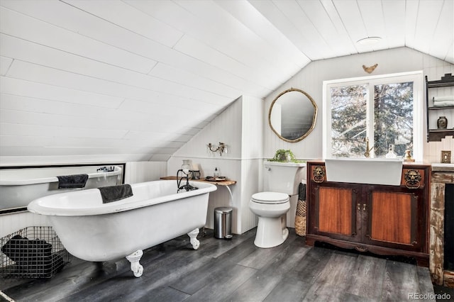 3 S Newton St, Denver, CO 80219 - bathroom featuring wood finished floors, vaulted ceiling, and a freestanding tub
