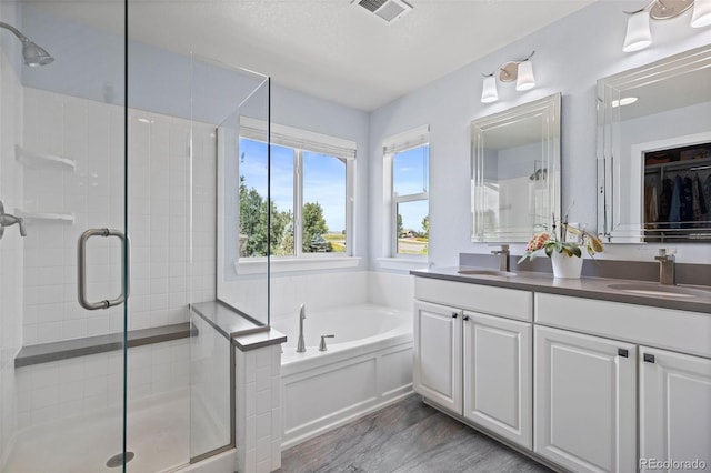 10388 Rutledge St, Parker, CO 80134 - full bath with a shower stall, double vanity, a bath, and wood finished floors