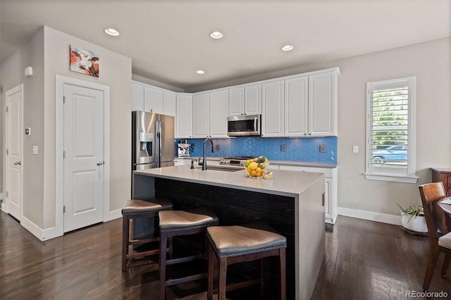 10388 Rutledge St, Parker, CO 80134 - kitchen featuring appliances with stainless steel finishes, dark wood-style floors, white cabinetry, and recessed lighting