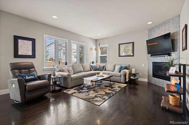 10388 Rutledge St, Parker, CO 80134 - living room featuring a large fireplace, wood finished floors, and recessed lighting