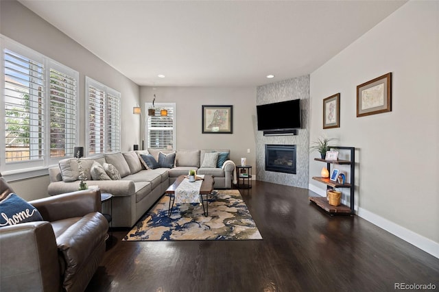 10388 Rutledge St, Parker, CO 80134 - living room featuring a large fireplace, wood finished floors, and recessed lighting