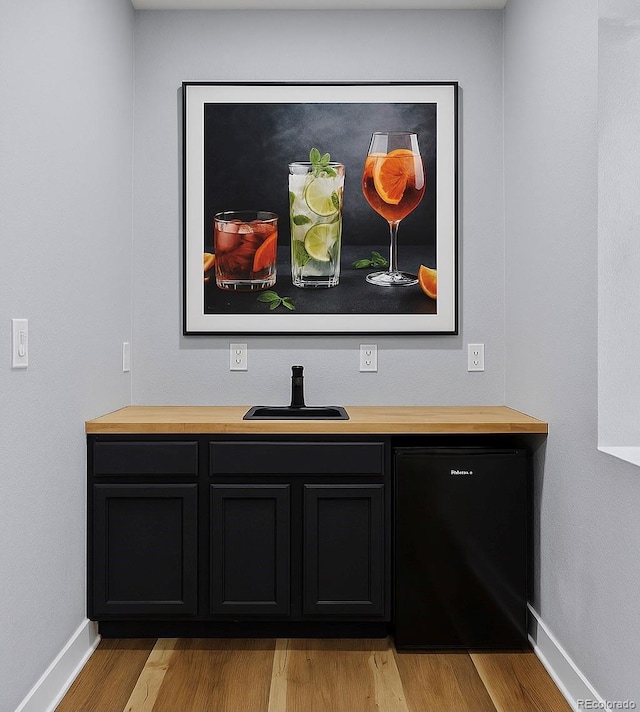 10388 Rutledge St, Parker, CO 80134 - detailed view of wood finished floors and black refrigerator