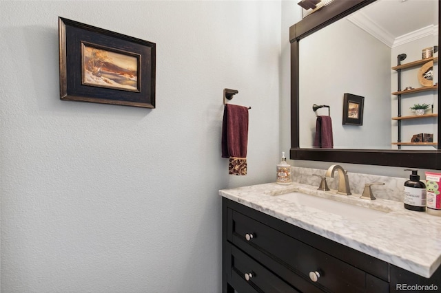 bathroom with ornamental molding and vanity