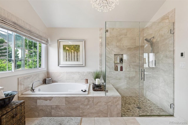 bathroom with vaulted ceiling, tile patterned floors, and plus walk in shower