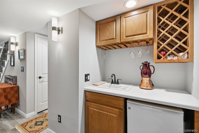 bar with white dishwasher and sink