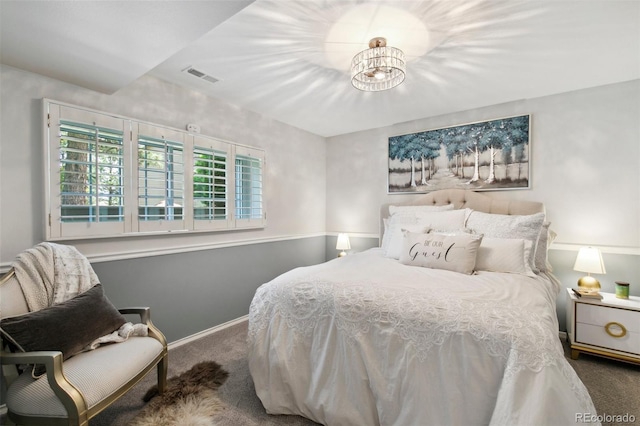 bedroom with carpet flooring and a notable chandelier