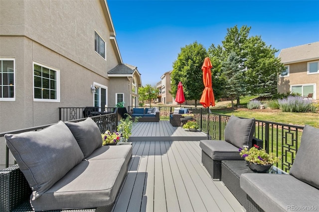 wooden terrace with outdoor lounge area and a yard