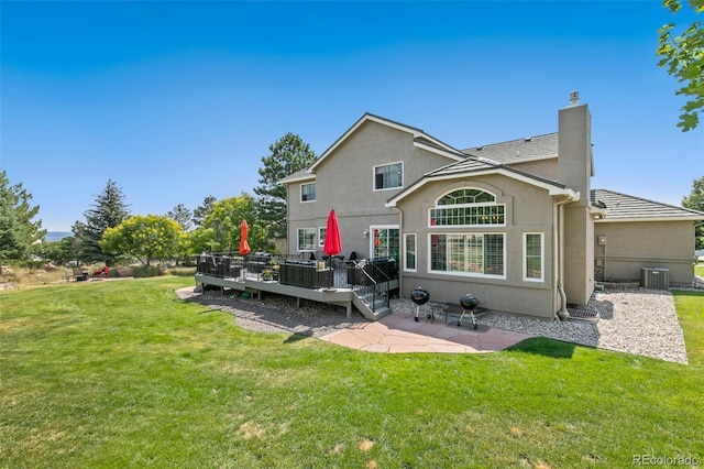 rear view of property featuring a patio area, central AC unit, a deck, and a lawn