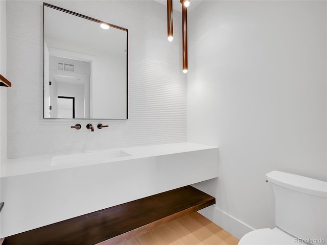 8132 Galileo Way, Littleton, CO 80125 - bathroom featuring toilet, vanity, and visible vents