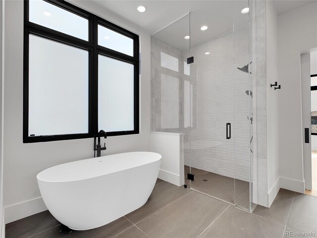 8132 Galileo Way, Littleton, CO 80125 - bathroom featuring a freestanding tub, recessed lighting, baseboards, a shower stall, and tile patterned floors