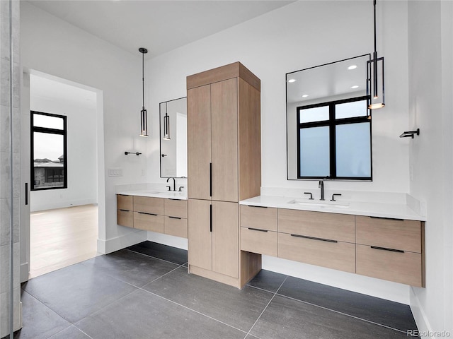 8132 Galileo Way, Littleton, CO 80125 - full bath with a sink, plenty of natural light, two vanities, and baseboards
