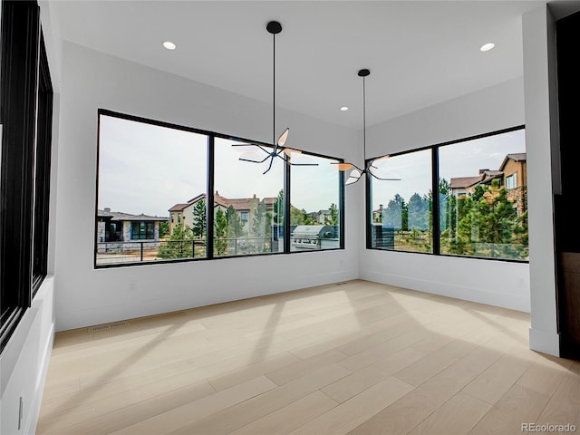 8132 Galileo Way, Littleton, CO 80125 - spare room with visible vents, light wood-style flooring, a chandelier, baseboards, and recessed lighting