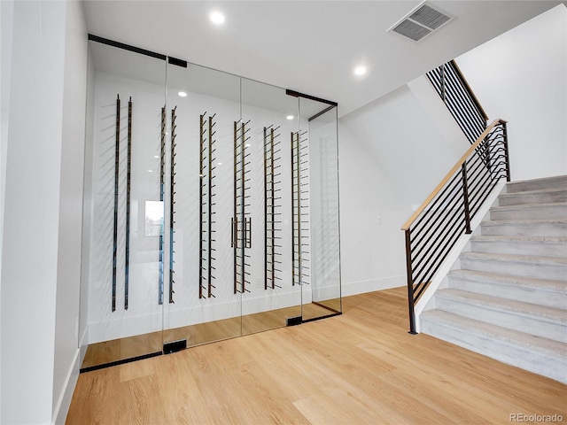 8132 Galileo Way, Littleton, CO 80125 - stairs featuring wood finished floors, recessed lighting, baseboards, and visible vents