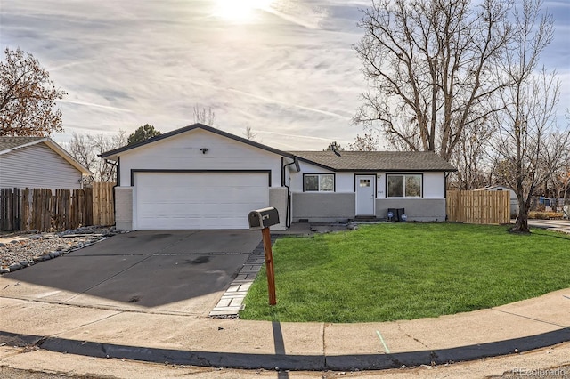 ranch-style home with a garage and a front lawn