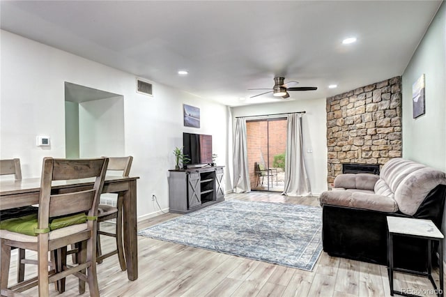 420 Wright St Unit 101, Lakewood, CO 80228 - living area with a stone fireplace, ceiling fan, light wood-style flooring, and recessed lighting